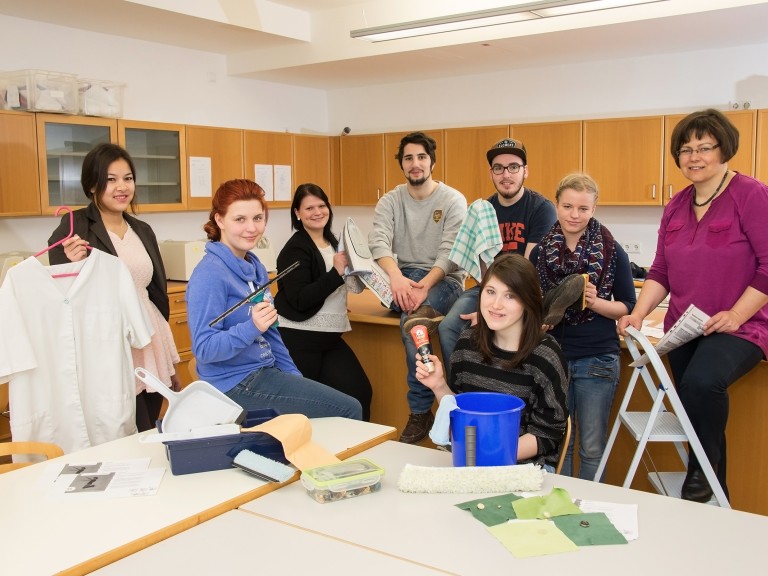 Eine Klasse von jungen Männern und Frauen in einer Schule für Hauswirtschaft