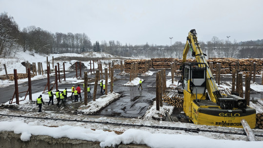 Blick auf Betriebsgelände von GELO Timber mit Holzvorräten und Maschinen